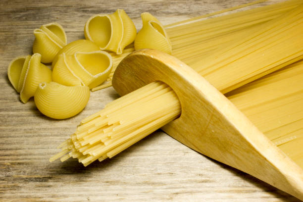 istock Spaghetti and wooden spoon on wooden background 538983318