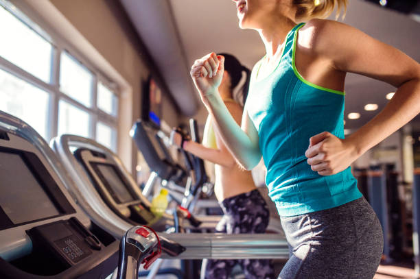 istock Two fit women running on treadmills in modern gym 538983490