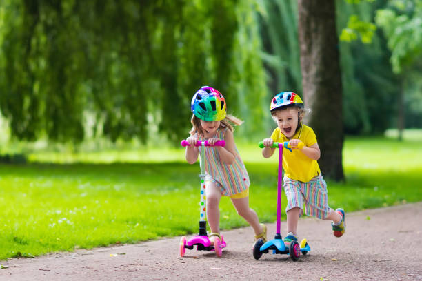 istock Little happy kids riding colorful scooters 538984042
