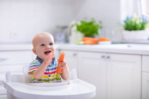 istock Funny little baby eating carrot 538985128