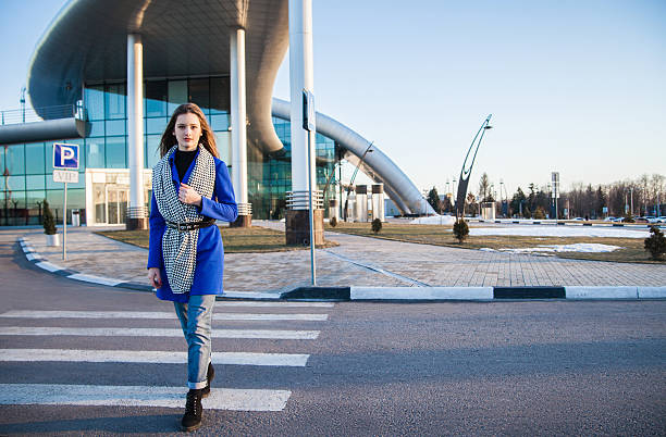 istock Side view of brunette in blue coat going on crosswalk 538985752
