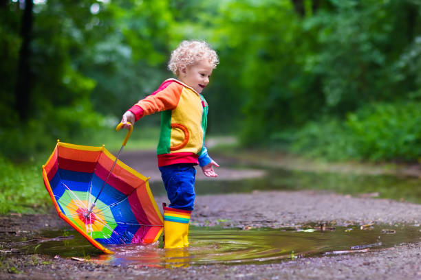 istock Happy child playing in the rain 538986408