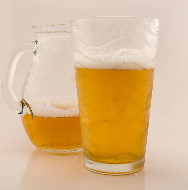 lager beer in glass mug with splash isolated on white background. Beer splash. Pub alcohol drink