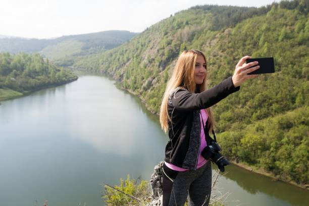 istock blond woman taking a selfie 538989798