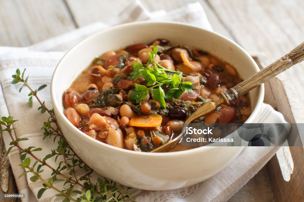 Cooked legumes and vegetables in a bowl Cooked legumes and vegetables in a bowl on the old wooden table Bean Stock Photo