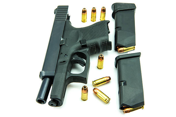 istock Black gun and 9mm bullets isolated a white background. 538991831