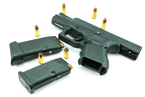 istock Black gun and 9mm bullets isolated a white background. 538991837