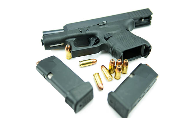 istock Black gun and 9mm bullets isolated a white background. 538992549