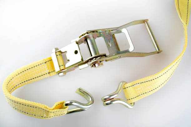 Yellow Ratchet truck cargo tie downs on white Ratchet truck cargo tie downs on white backrounds strap stock pictures, royalty-free photos & images