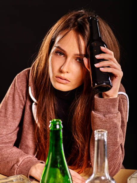 istock Drunk girl holding bottle of vodka. 538992786