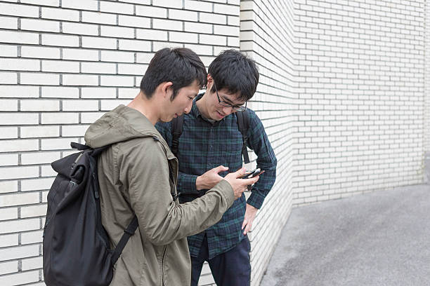 istock Young japanese students checking internet on smartphone  in kyoto japan 538993348