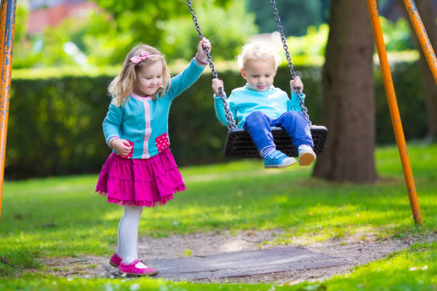 istock Beautiful kids on playground swing 538993898