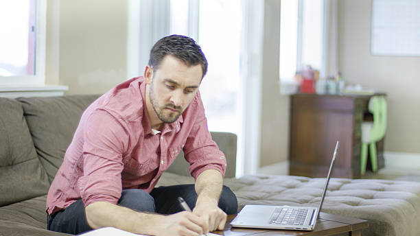 istock Young adult working on his finances at home 538994280