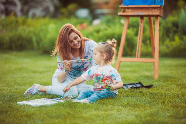 istock Mother and little daughter paint together 538994292