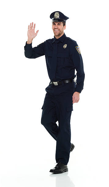 istock Smiling police waving hand 538995296