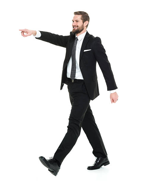 istock Smiling businessman pointing and walking 538996488