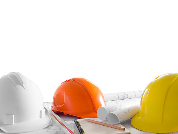 istock safety helmet and architect blueprints on table over white backg 538996619