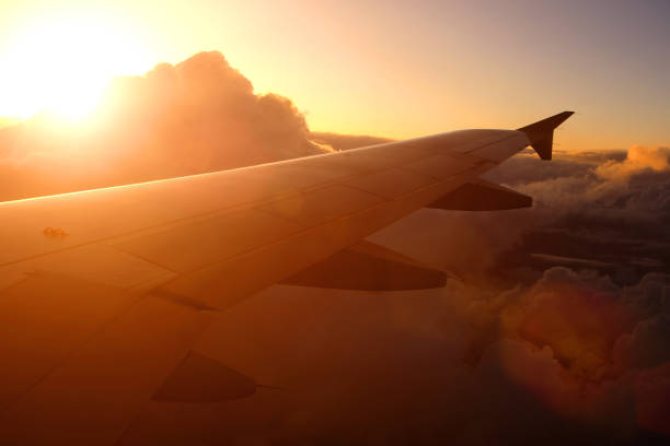 istock Airplane flying above clouds at sunset 538997198