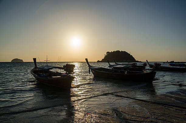 istock Wood boats on the beach at sunrise 538997555