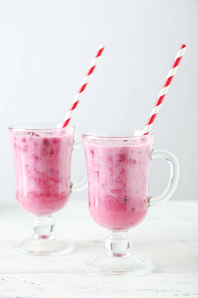 istock Pomegranate smoothie in glass on white wooden background 538997633