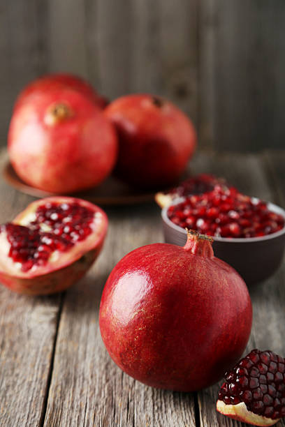 istock Delicious pomegranate fruit on grey wooden background 538997983
