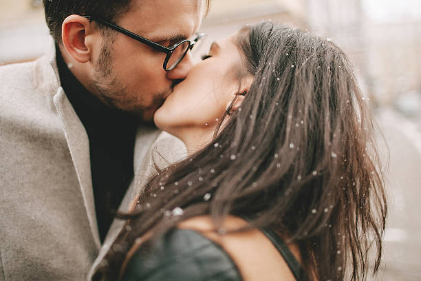Young couple is kissing on the street stock photo