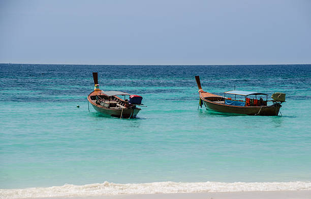 istock Wood boats on the beach with blue sky background 538998193