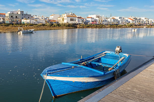 Traditional Portuguese boat at the dock. View Cabanas de Tavira. Traditional Portuguese boat at the dock. View Cabanas de Tavira. faro district portugal photos stock pictures, royalty-free photos & images