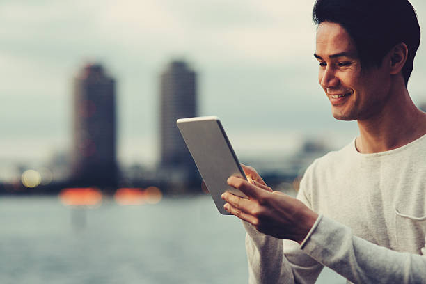 istock Young japanese man texting on the tablet 538999220