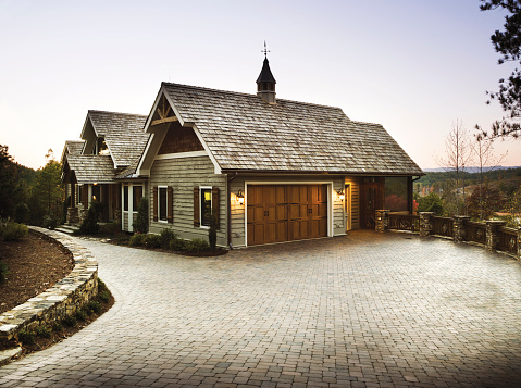 A garage entrance to a home with a brick driveway.