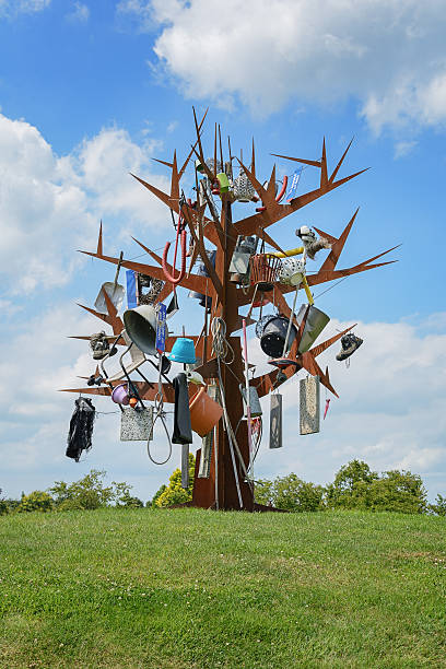 Appeltern, The Netherlands, July 22, 2015: The Gardens of Appeltern is the inspiration garden park in the Netherlands. In this picture a garden with a modern artwork, a decorated rusty iron tree.