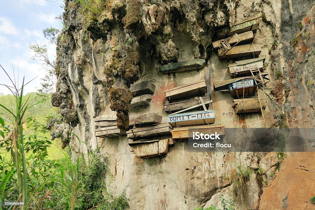 Hanging Coffins of Sagada, Philippines Philippinos in the mountain region of Sagada used to hang coffins with their dead down a cliff as a burial tradition in Echo Valley, Sagada, Northern Luzon, Philippines Hanging Stock Photo