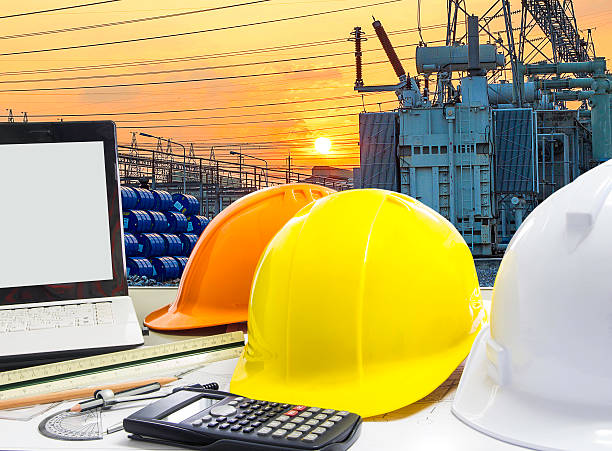 istock safety helmet and architect blueprints on table over building co 539000713