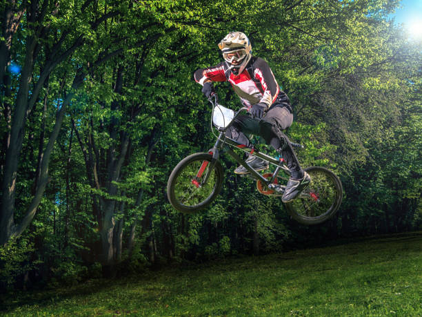istock Young bmx bicycle rider on background of trees 539000834