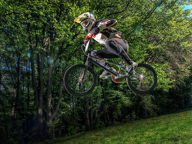 istock Young bmx bicycle rider on background of trees 539001616