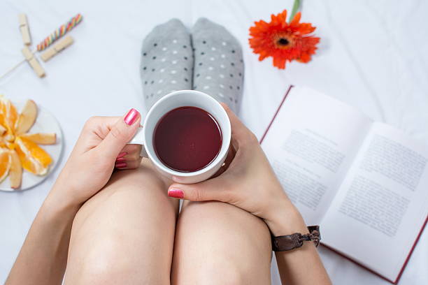 istock Woman with cup of tea in bed 539001840