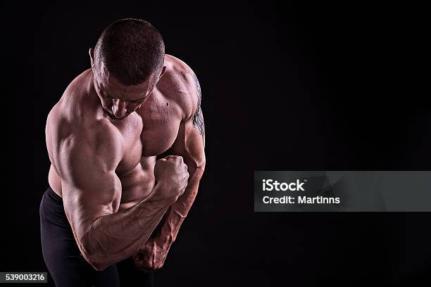 Bodybuilder In Studio Over Dark Background Stock Photo - Download Image Now  - Abdominal Muscle, Activity, Adult - iStock