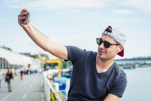 istock Beauty guy sitting on the fence and make selfie 539003258