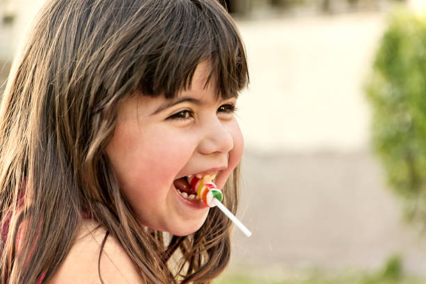istock Little girl smiling with lollipop 539005082