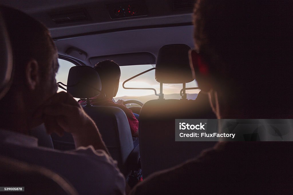 group of people is traveling  , exploring four friends are traveling , exploring the world and having an adventure , going on a road trip Mini Van Stock Photo