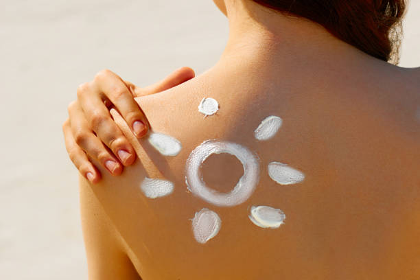 istock Woman in bikini with the drawn sun on a shoulder 539006212