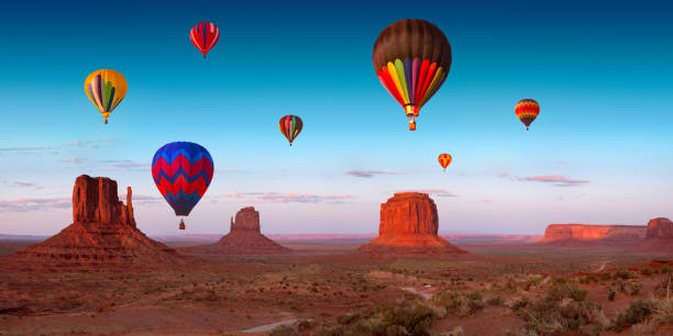 Their dream flight at dream place Some hot air balloons over Monument Valley at sunset hour. This is a 9740 pixel panoramic photograph. monument valley tribal park photos stock pictures, royalty-free photos & images