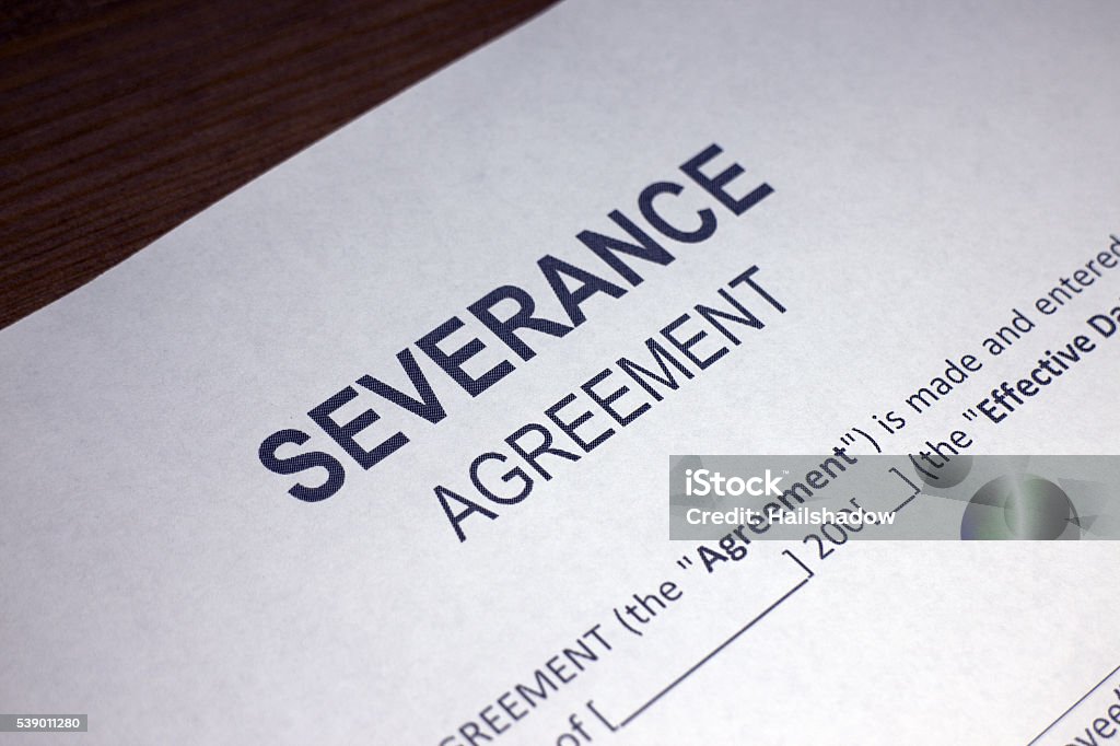 Severance Agreement Someone filling out Severance Agreement. Separation Stock Photo