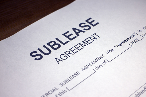 Someone filling out Sublease Agreement.