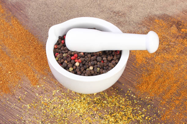 istock Colorful pepper in mortar and powdery pepper on rustic boards 539011804