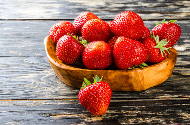 istock Strawberry on a dark wooden background. 539012382