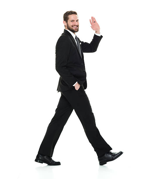 istock Cheerful businessman waving hand and walking 539013946