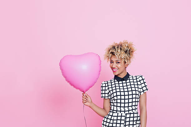 istock Young woman with big pink heart 539016316
