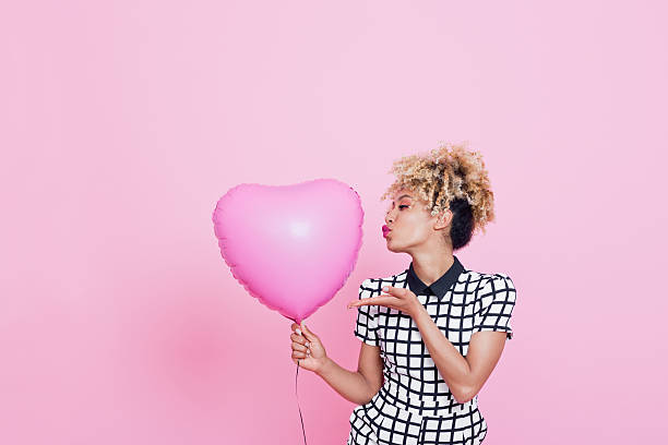 young woman with big pink heart - kvinna ballonger bildbanksfoton och bilder