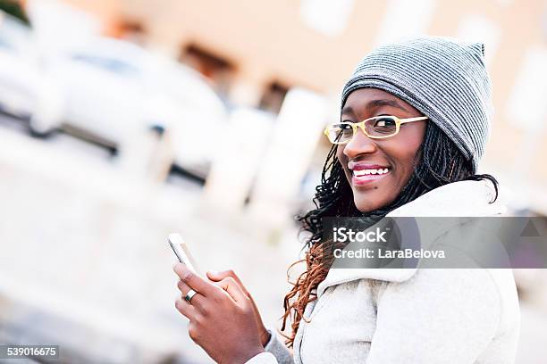 Young African Woman Messaging On Smart Phone Stock Photo - Download Image Now - 18-19 Years, 20-29 Years, Adult